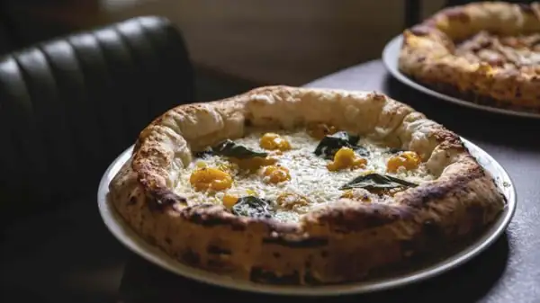 Broccia in Rome, at the all-day restaurant in San Lorenzo, offering pizza, cooking, and smart working