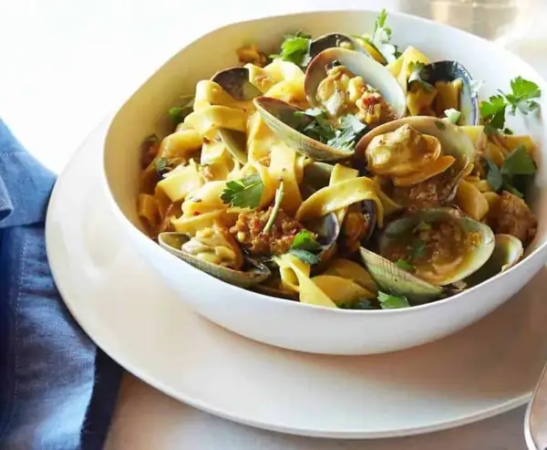Fettuccine with Manila Clams, Spicy Sausage and White Wine Saffron Reduction
