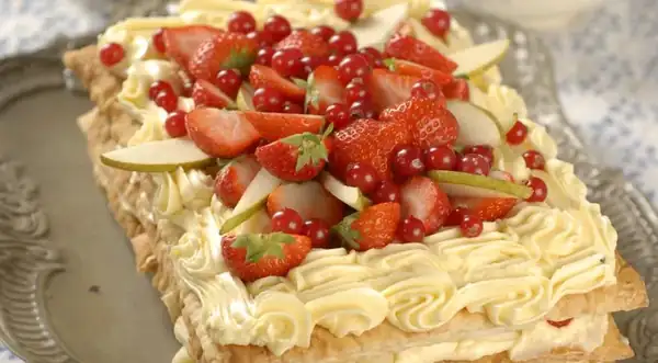 Fruit and berry Napoleon cake in mint syrup