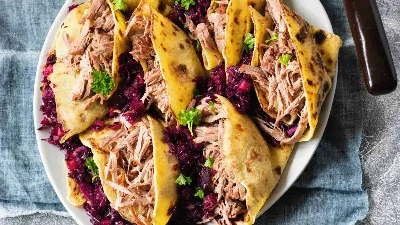 Pulled turkey leg with cabbage and potato pancakes