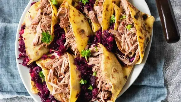 Pulled turkey leg with cabbage and potato pancakes