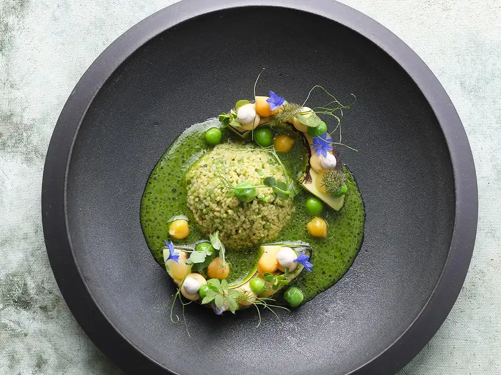 Roasted avocado with pea couscous, spiced kefir and lemon
