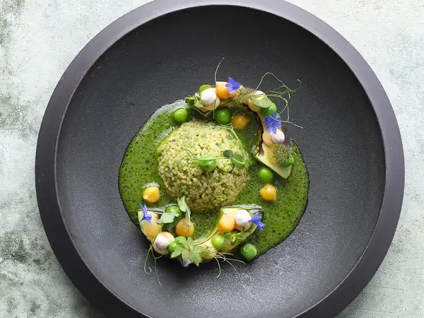 Roasted avocado with pea couscous, spiced kefir and lemon