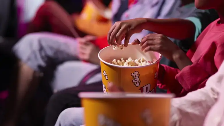Here's Why Popcorn Tastes So Much Better At The Movie Theater