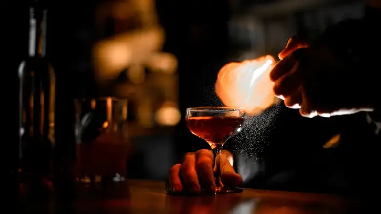 How do flaming cocktails burn and what effect does it have on the flavor?