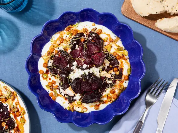 Smashed beetroot on garlic yogurt with chickpeas and pomegranate syrup