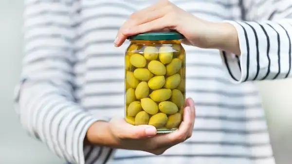 Why You Should Stop Throwing Out Olive Brine (And Add It To A Marinade Instead)