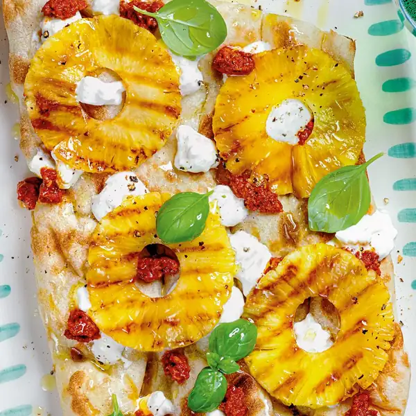 Pinsa with 'nduja, stracciatella, and pineapple