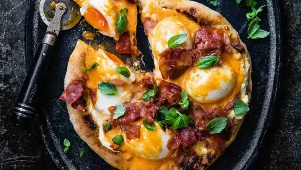 Pizza with eggs Benedict and buffalo sauce