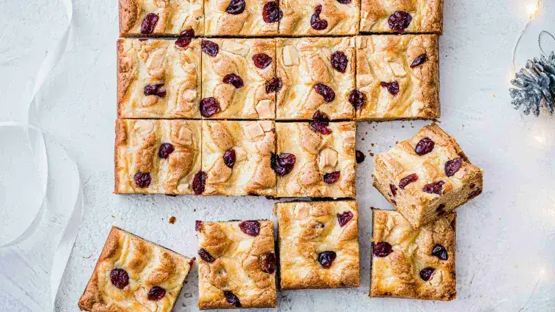 Blondies with white chocolate and cranberries, marbled with cream cheese