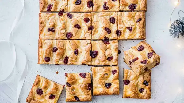 Blondies with white chocolate and cranberries, marbled with cream cheese
