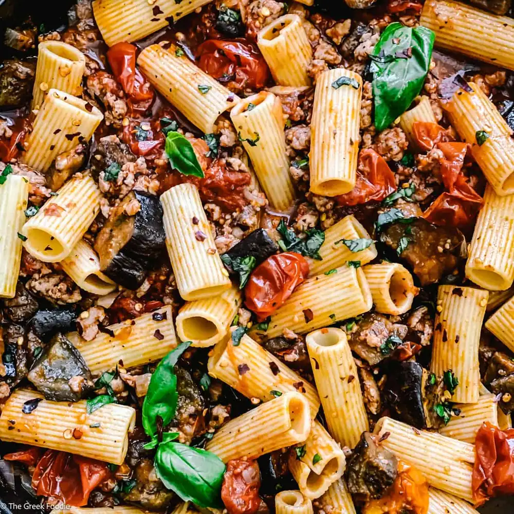 This delicious roasted eggplant pasta with tomatoes and sweet Greek sausage is perfect for a weeknight dinner