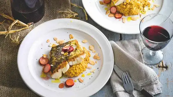 Baked hake with pumpkin, carrot and almond puree and pickled radishes