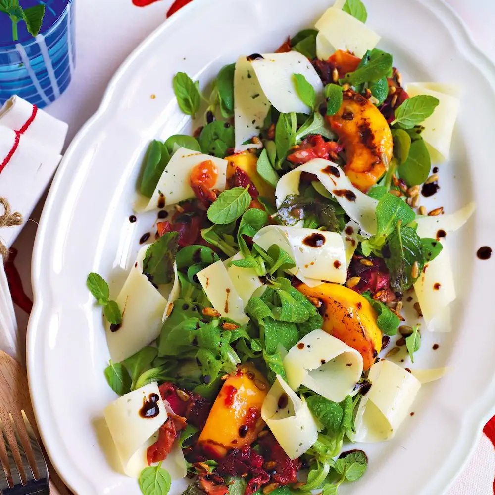 Valerian and peach salad with casera cheese, garum sunflower seeds and fig oil