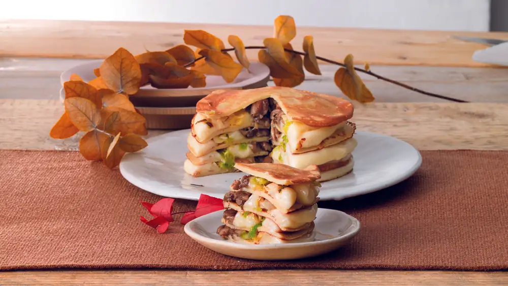 Vegetarian menu: buckwheat crepe cake, taleggio cheese, and mushrooms