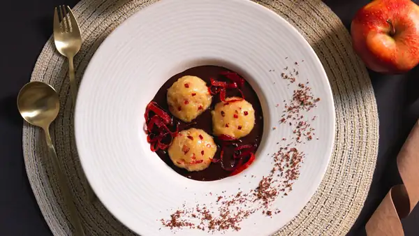 Sweet apple dumplings with chocolate sauce