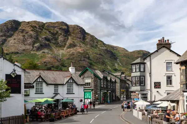 “A tranquil autumn alternative to Ambleside”: The charming Lake District village with glacial lake views, cosy historic pubs & vintage markets without the crowds