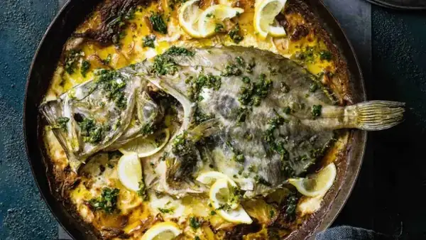 Baked St. Peter's fish with potatoes, fennel and salsa verde