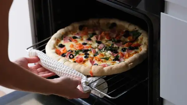 Where's The Best Spot In The Oven For Reheating Pizza And Maintaining A Crispy Crust?