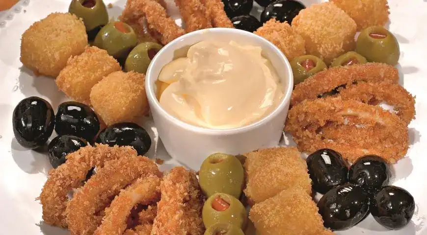 Squid rings with cheese, olives, and black olives