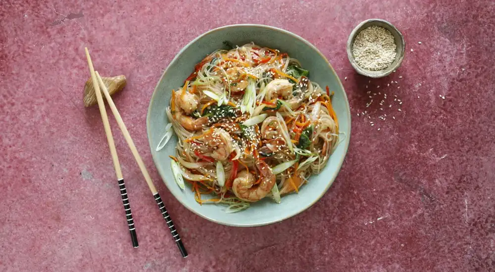 Funchoza with shrimp and vegetables in teriyaki sauce