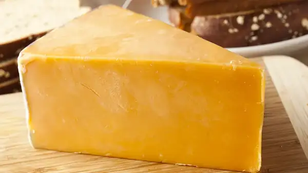 The Fascinating History Behind Why Some Cheese Has That Bright Orange Color
