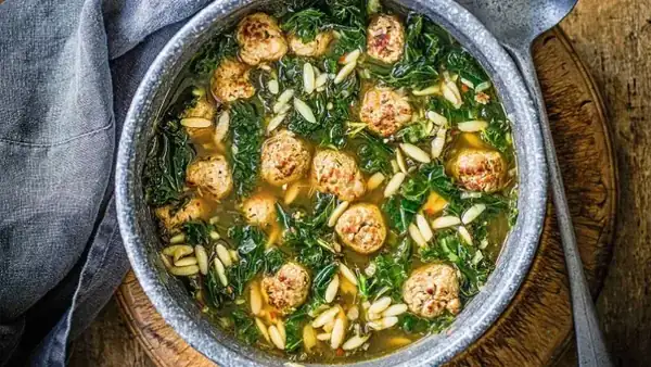 Hearty soup with kale and meatballs