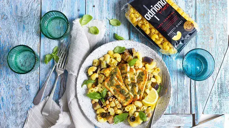 Al dente pasta with roasted eggplant, cheese and mint or Greece on a plate