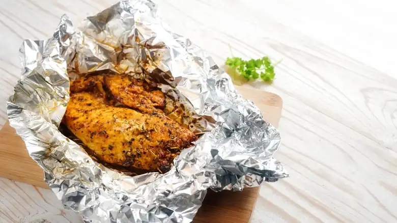 The Juicy Reason To Reheat Meat In Aluminum Foil
